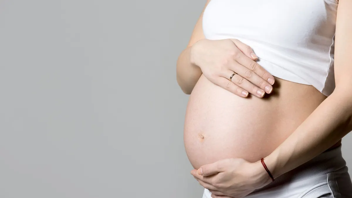 mulher gravida segurando a barriga
