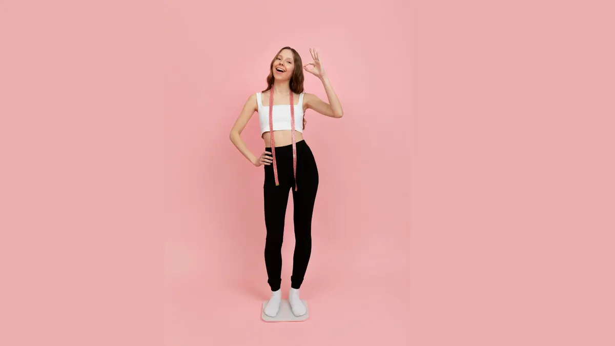 Mulher com fita métrica em fundo rosa
